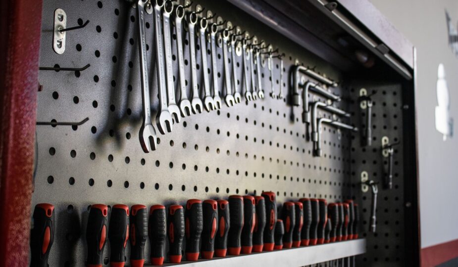 A collection of hand tools neatly arranged on a pegboard for easy access and organization.