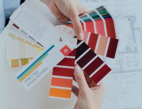 Person choosing color palettes for interior design projects, emphasizing creative choices.