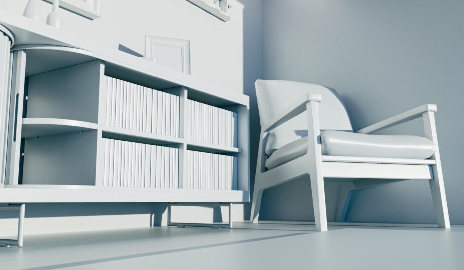 Minimalist white interior featuring a modern armchair and a stylish bookshelf.