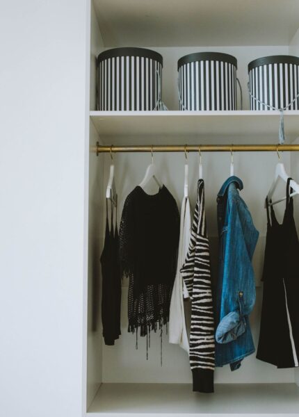 Organized wardrobe with trendy clothes, hangers, and storage boxes.