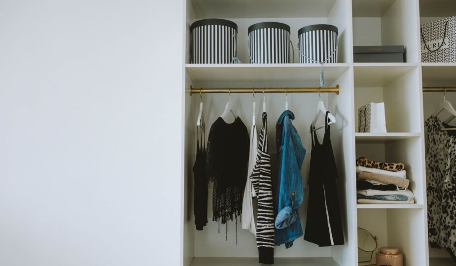 Organized wardrobe with trendy clothes, hangers, and storage boxes.