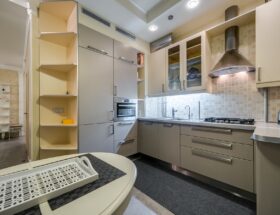 Sleek modern kitchen with neutral tones and stainless steel appliances.