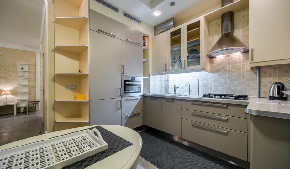 Sleek modern kitchen with neutral tones and stainless steel appliances.