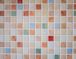 Bright and colorful mosaic tiles arranged in a square pattern creating a vibrant backdrop.