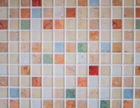 Bright and colorful mosaic tiles arranged in a square pattern creating a vibrant backdrop.