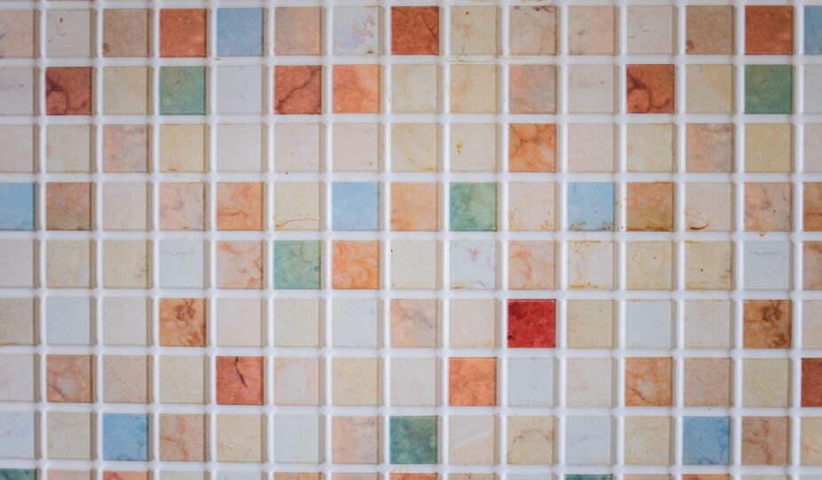 Bright and colorful mosaic tiles arranged in a square pattern creating a vibrant backdrop.