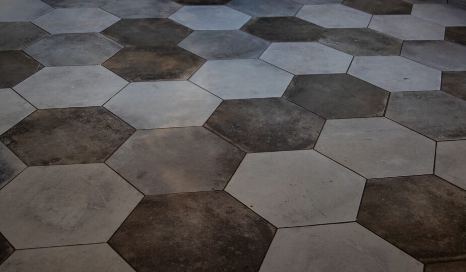 Elegant hexagonal floor tiles create a striking marble pattern, perfect for modern interiors.