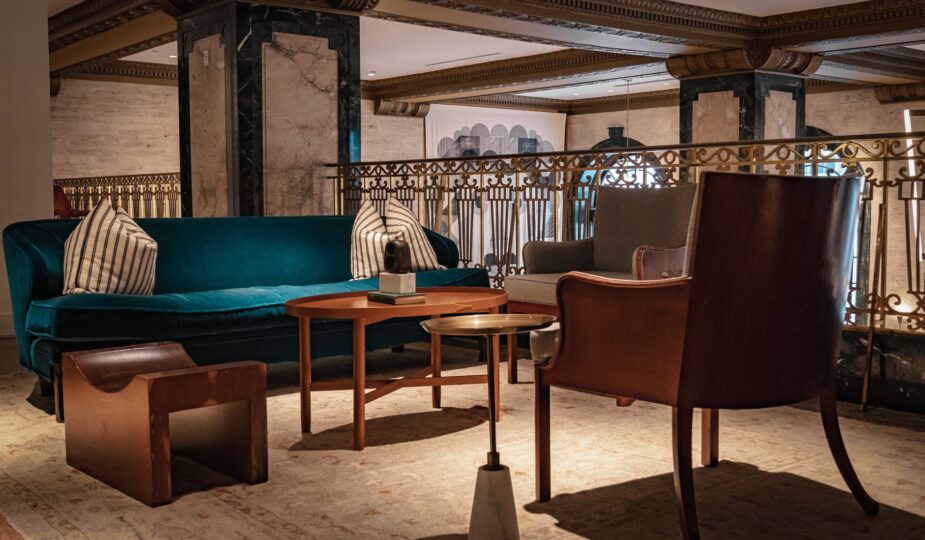 Cozy and elegant lounge area featuring velvet sofa and stylish armchairs.